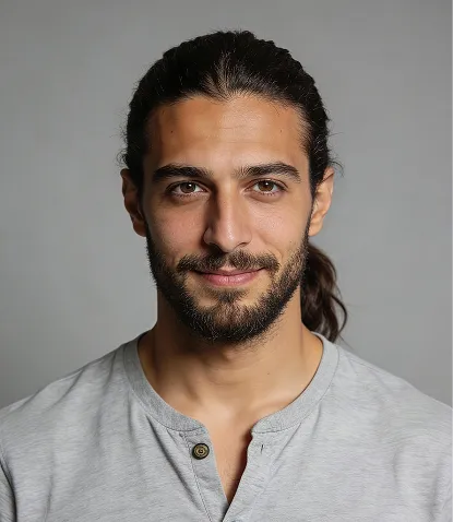 Portrait of Rohan Malhotra, UI/UX Designer — man with dark hair tied back and a beard in a light gray shirt.